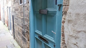 A teal door with a sign reading "Book House 7 Ellerby Lane". - Book House (Whitby)