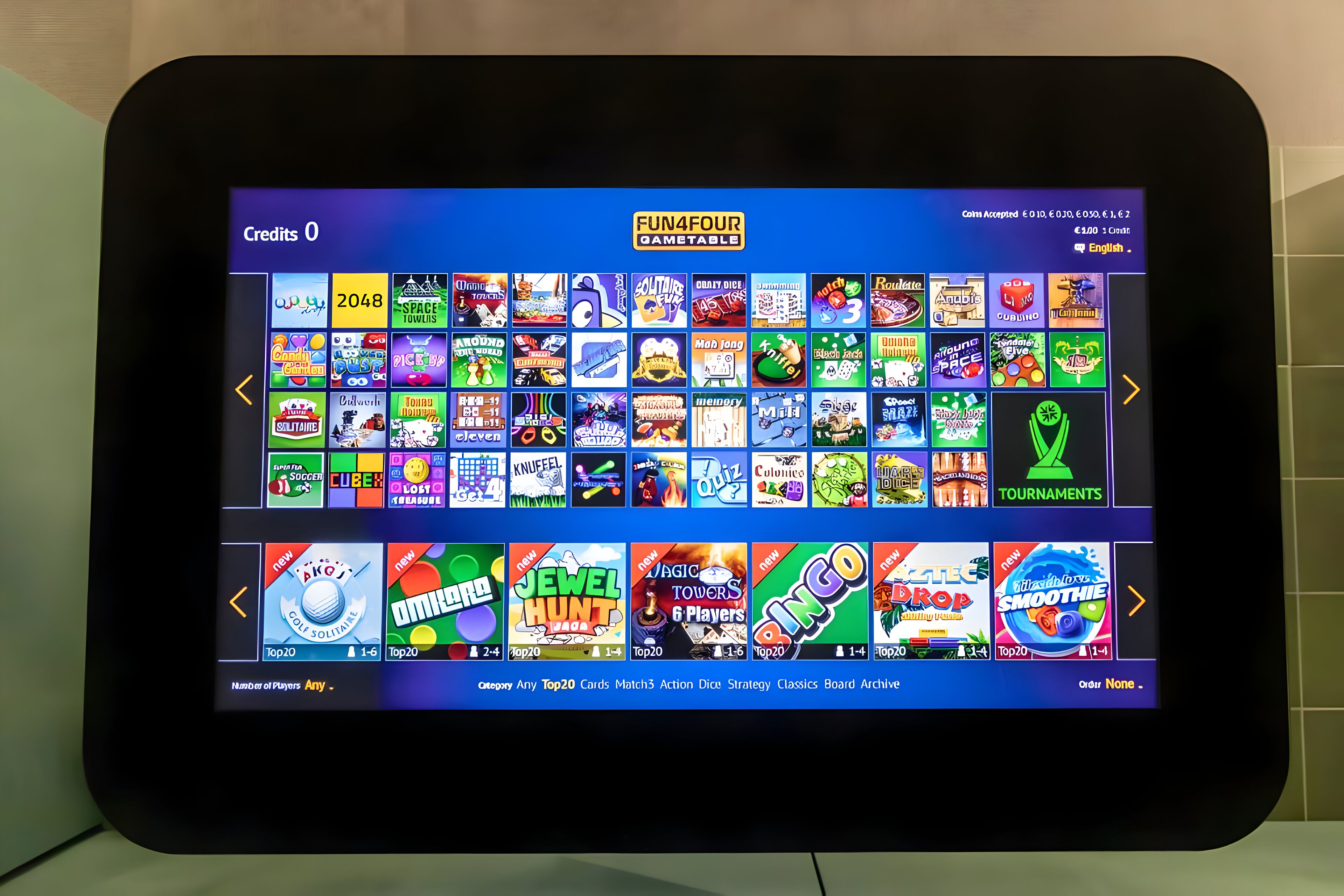 A tablet displaying a variety of mobile games with colorful icons and titles.