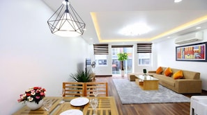 City Apartment | Living area | 56-inch LCD TV with cable channels, fireplace