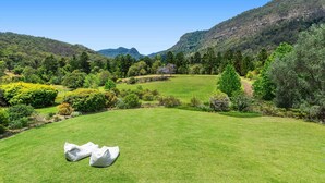 A golf course with a clear view of the surrounding hills and trees.