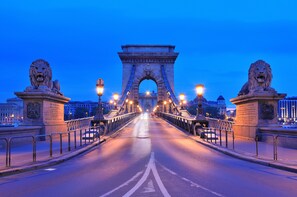 Spanning the landscape, this iconic bridge features a central archway flanked by lion statues.