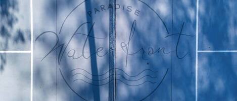 A tiled wall with the words 'Paradise Waterfront' and a wavy line design.