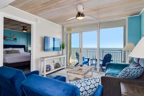 Enjoy a room with a large bed, seating area, and ocean view from the balcony.