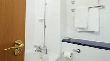 A bathroom with a shower, toilet, and sink.