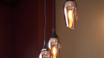 Three pendant lights with exposed bulbs hanging from a ceiling.