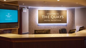 A hotel reception area with a sign reading "Welcome to The Quays Hotel Reception". - The Quays By Greene King Inns (Northampton)