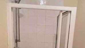 A glass-enclosed shower stall with a handheld showerhead and a wall-mounted faucet. - Flat 3, 52 Sneinton Hermitage Nottingham NG2 4BS (Nottingham)