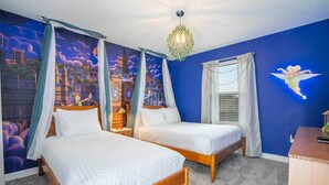 A bedroom with two beds, a mural of a cityscape, a chandelier, and a nightstand with a lamp. - Magnificient 4Bd w/ Pool @ Storey Lake Resort 2648 (Kissimmee)