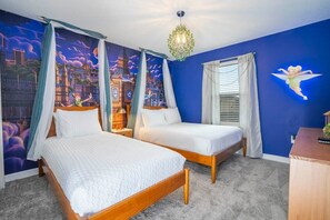 A bedroom with two beds, a mural of a cityscape, a chandelier, and a nightstand with a lamp. - Magnificient 4Bd w/ Pool @ Storey Lake Resort 2648 (Kissimmee)