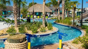 A pool area with lounge chairs, palm trees, and a thatched-roof structure. - Magnificient 4Bd w/ Pool @ Storey Lake Resort 2648 (Kissimmee)
