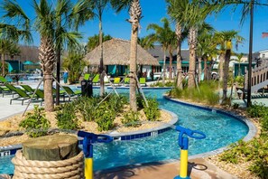 A pool area with lounge chairs, palm trees, and a thatched-roof hut. - Magnificient 4Bd w/ Pool @ Storey Lake Resort 2648 (Kissimmee)