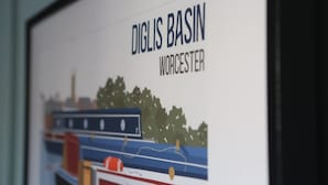 Une photographie encadrée représentant une scène de rivière avec des bateaux et des arbres, portant la légende « DIGLIS BASIN WORCESTER ».