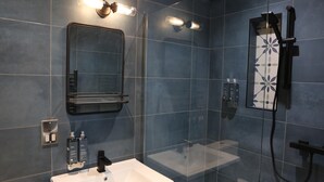 A modern bathroom with a white sink, a mirror, and a shower enclosure. - Hop Market - Ensuite Bedroom (Worcester)