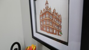 A framed architectural drawing of a building with multiple windows and a tower. - Hop Market - Ensuite Bedroom (Worcester)