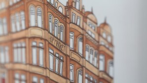 A detailed architectural drawing of a multi-story building with arched windows and a shop sign. - Hop Market - Ensuite Bedroom (Worcester)