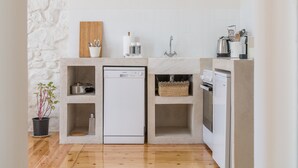 Una cocina compacta equipada con lavavajillas, horno integrado y pileta.