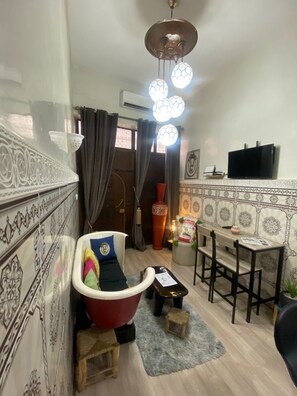 Cozy living space with a traditional design, featuring a dining area and a comfortable seating area.