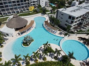A resort with multiple swimming pools, a central water feature, and a thatched-roof structure. - Beach Access, 4 Beds, 2 Bedroom, 2 Bath Quadrant 4107 (Bucerías)