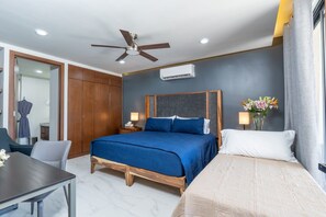 A hotel room with a large bed, a desk, a chair, a ceiling fan, and an air conditioning unit. - Beach Access, 4 Beds, 2 Bedroom, 2 Bath Quadrant 4107 (Bucerías)