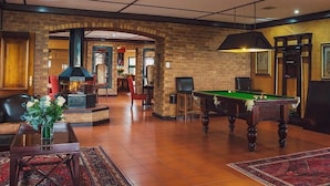 A spacious indoor area with a pool table, a fireplace, and a seating area. - Cussonia Country Home (Tierpoort)