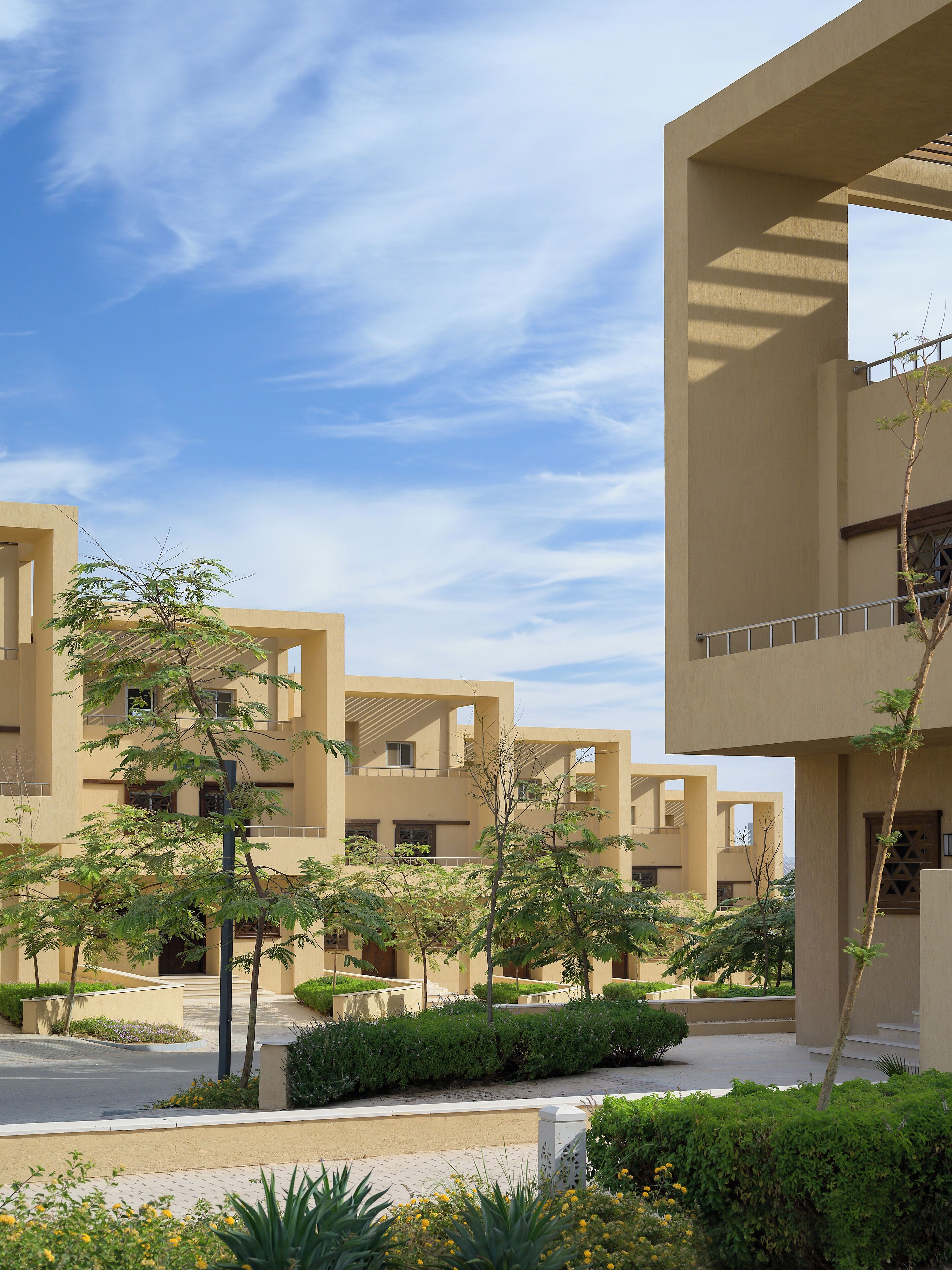 A modern building with multiple balconies and a clear sky.