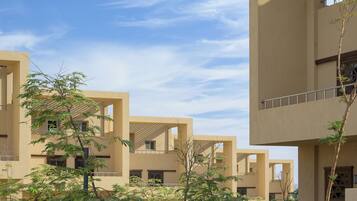 A modern building with multiple balconies and a clear sky.