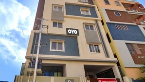 A multi-story building with a sign reading "OYO" on the facade.