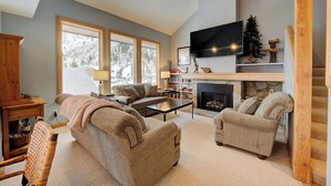 A cozy living room with a fireplace, comfortable seating, and a television. - The Baldy Traverse Retreat ski-in/out to Snowbird complimentary shuttle to Alta (Snowbird)