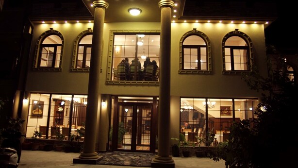 A building with a grand entrance, large columns, and multiple windows. - ROZAFA (Bujanovac)