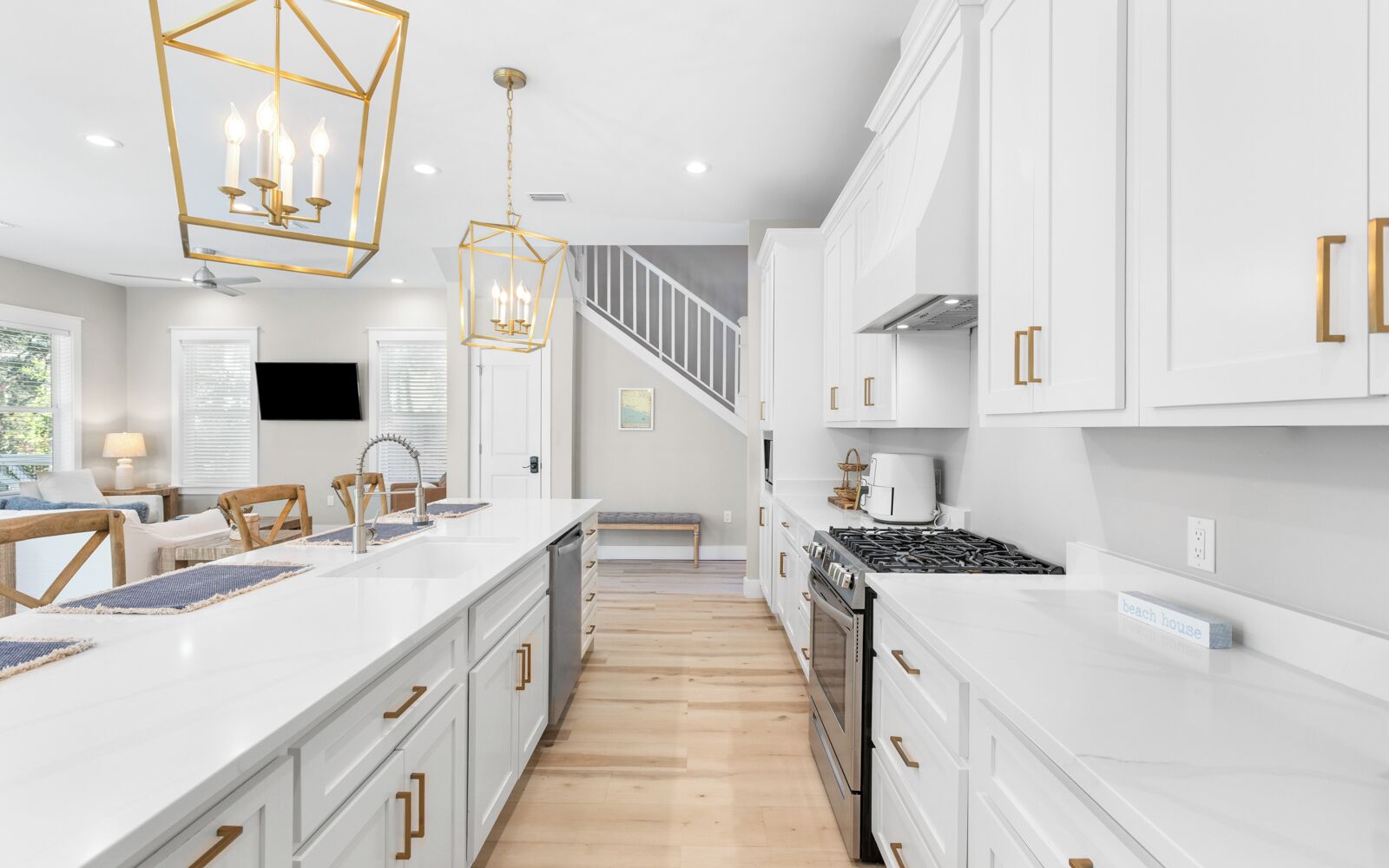 A modern kitchen with white cabinets, a central island, and a stove.