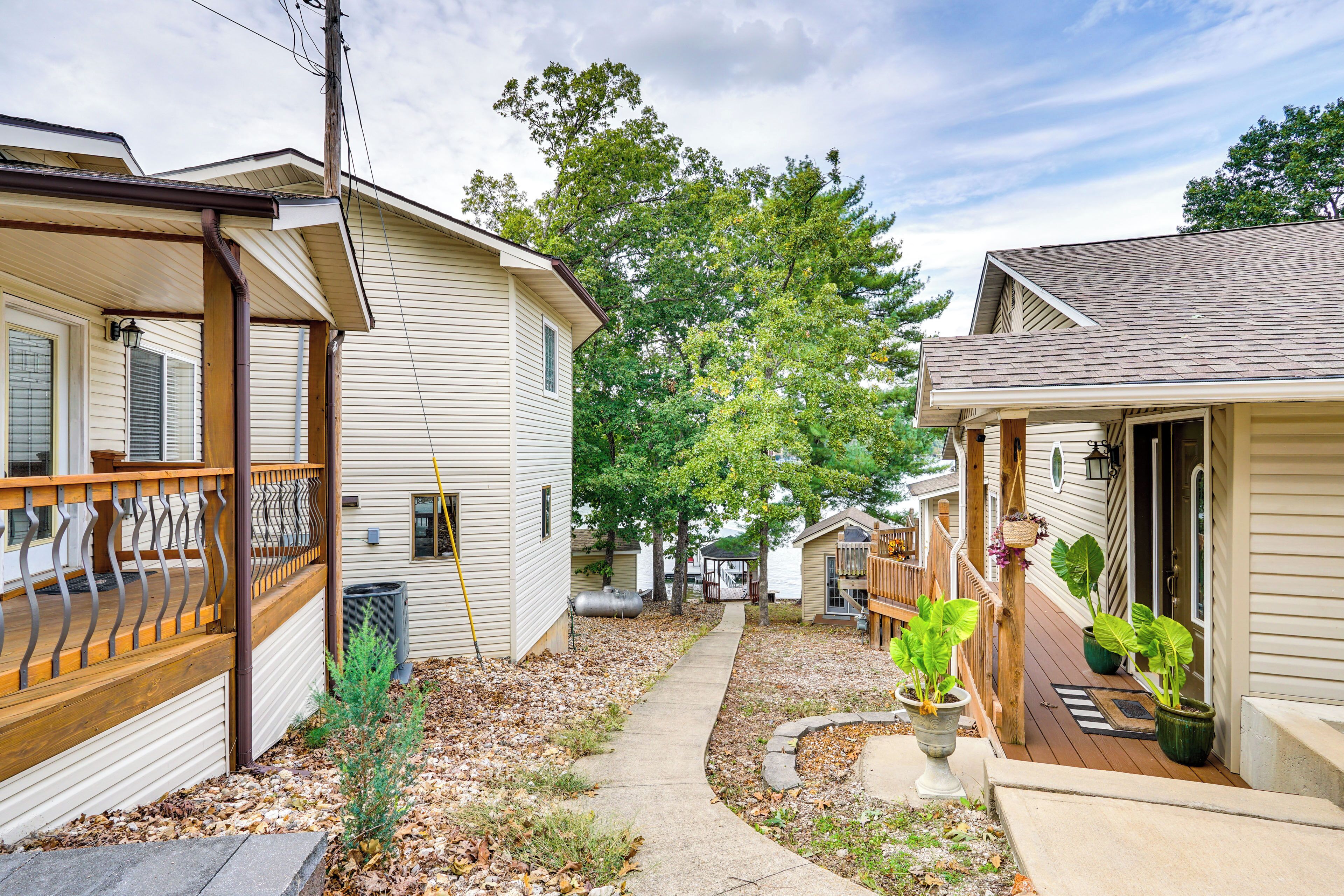 A residential area with multiple houses, a pathway, and some potted plants.