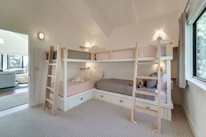 A bunk bed room with a herringbone-patterned carpet, a wooden ladder, and a window with curtains. - Steps to Beach: Family Home w/ Views in Tahoe City (Tahoe City)