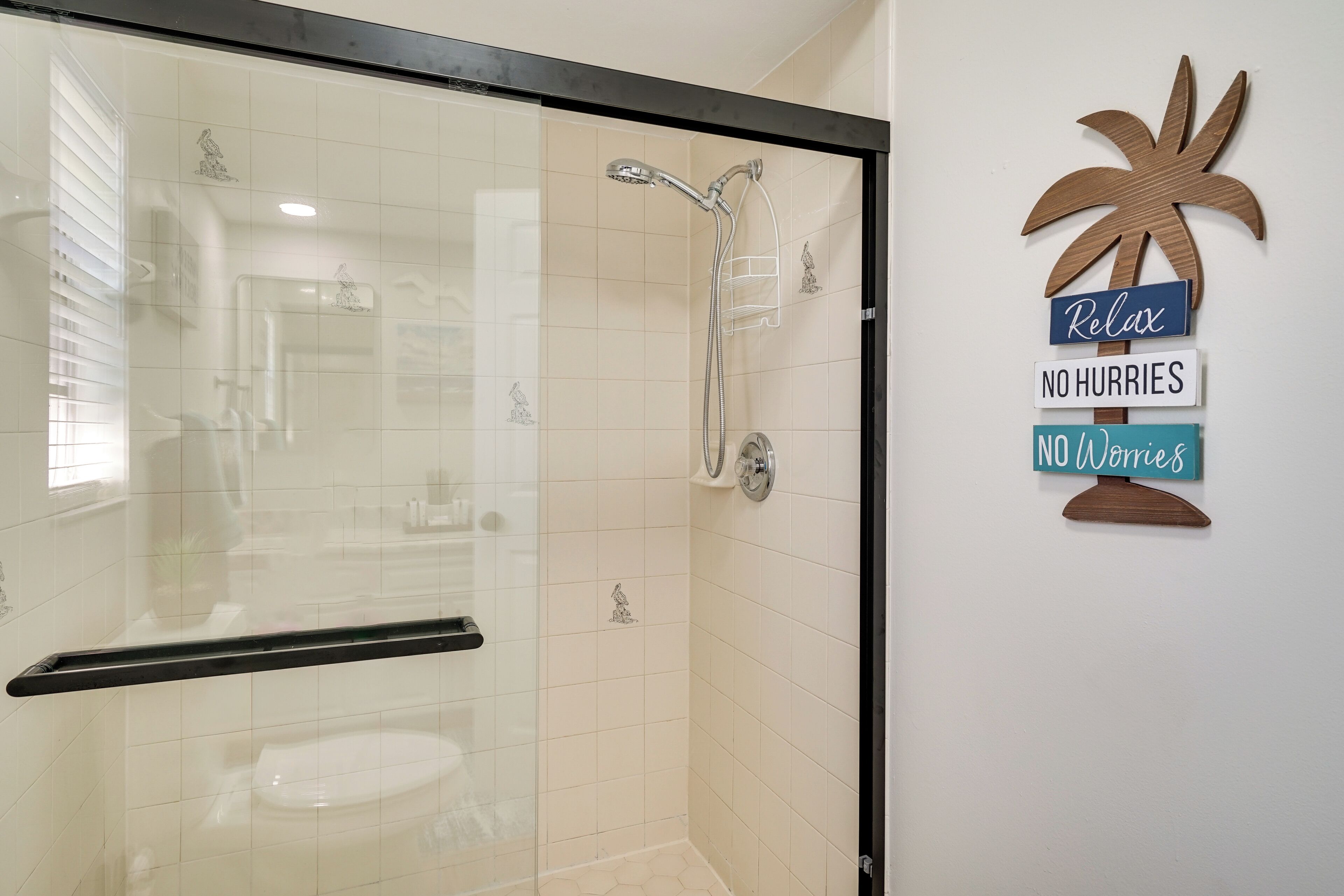 A modern bathroom with a glass-enclosed shower, a toilet, and a wall-mounted towel rack.