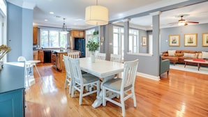 A spacious kitchen with a dining area, wooden flooring, and a ceiling fan. - Waterfront Lusby Escape w/ Fire Pit & Kayaks! (Lusby)