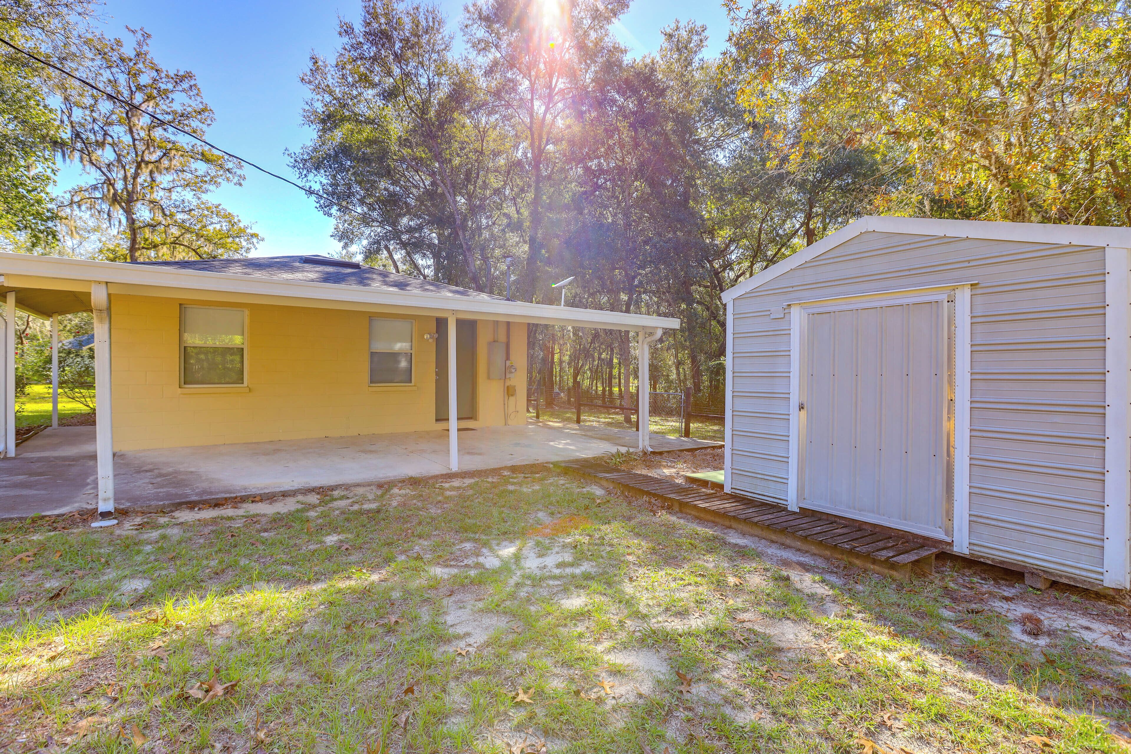 A yellow building with a covered porch and a garage.