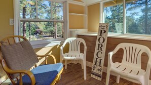 A room with wooden flooring, a blue cushioned chair, a wooden chair with a brown cushion, and two white plastic chairs. - 2 Mi to Dtwn: Prescott Gem w/ Patio & Views! (Prescott)