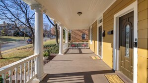 A covered porch with a white railing, a welcome mat, and a door with a window. - Cozy Roanoke Vacation Rental: 2 Mi to Downtown! (Roanoke)