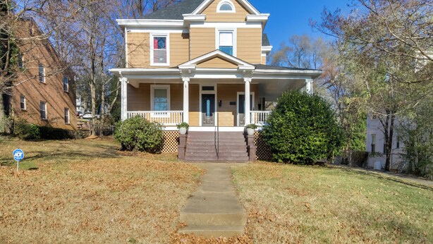 A two-story house with a front porch, a central entrance, and a small front yard. - Cozy Roanoke Vacation Rental: 2 Mi to Downtown! (Roanoke)