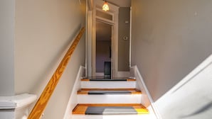A staircase with wooden handrails and a light fixture at the top. - Cozy Roanoke Vacation Rental: 2 Mi to Downtown! (Roanoke)