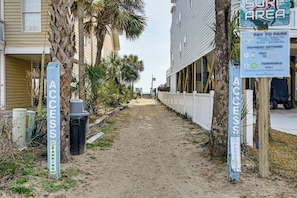 A sandy path leading to a building with a 'GOLF CART PARKING ONLY' sign. - Walk to Ocean: Surfside Beach Gem w/ Private Pool (Surfside Beach)