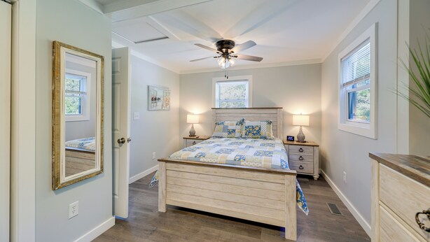 A bedroom with a bed, bedside tables, a ceiling fan, and a window. - New Bern Vacation Rental: Close to Neuse River! (New Bern)