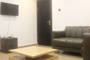 One Bedroom Suite | Living area | 42-inch Smart TV with satellite channels