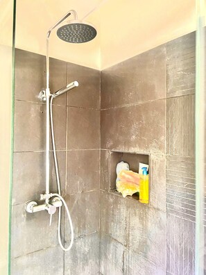 Enjoy a refreshing shower with a handheld showerhead and wall-mounted faucet, plus convenient storage for your essentials.