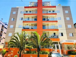 Un edificio de varios pisos con balcones, una sección central roja y un letrero que dice 'ED. MADAGASCAR 58'.