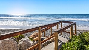 A wooden boardwalk leading to a beach with a clear view of the ocean. - Oceanfront Family Getaway | BBQ | Outdoor Seating (Oceanside)