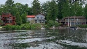 A river with houses on the banks, surrounded by trees. - Camp Serenity
 (Wilton)
