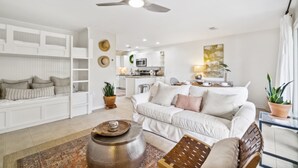 A modern living room with a white sofa, a coffee table, and a ceiling fan. - Beachwood Villas by Panhandle Getaways (Santa Rosa Beach)