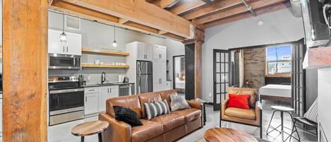 A modern interior with a kitchen, living area, and dining space.
