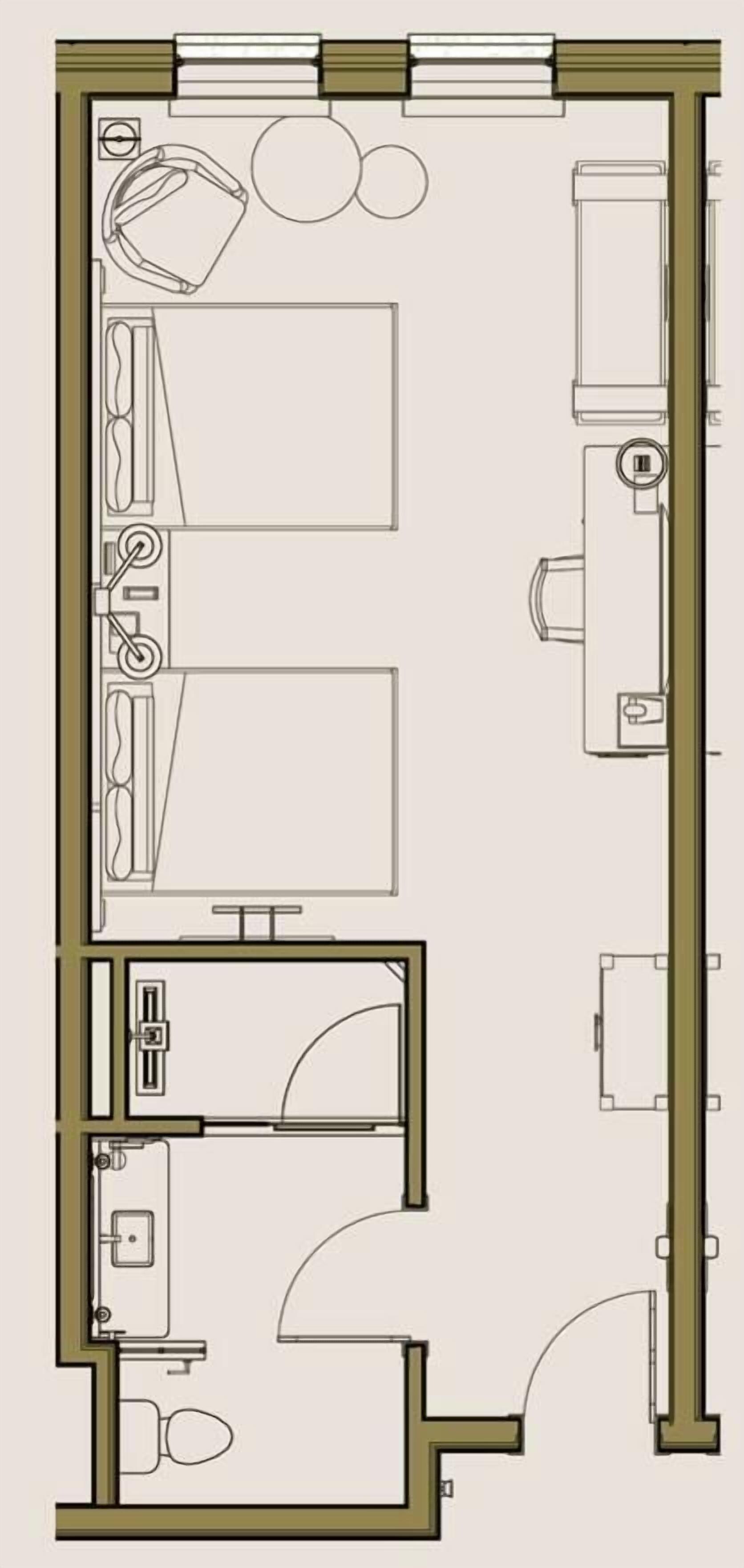 A floor plan of a hotel room with a bathroom, a kitchenette, a bed, and a seating area.