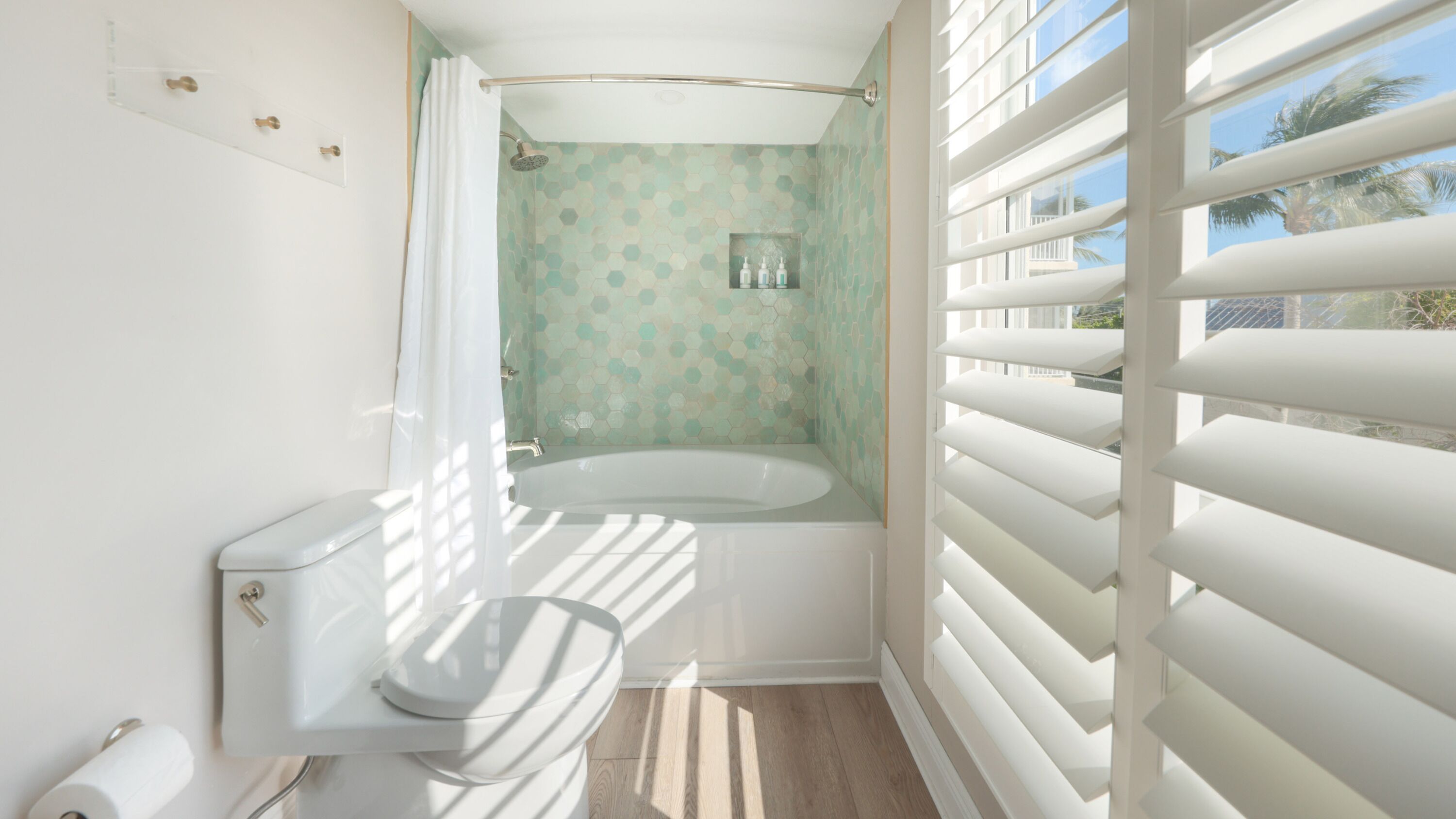 A bathroom with a toilet, a bathtub, and a shower.